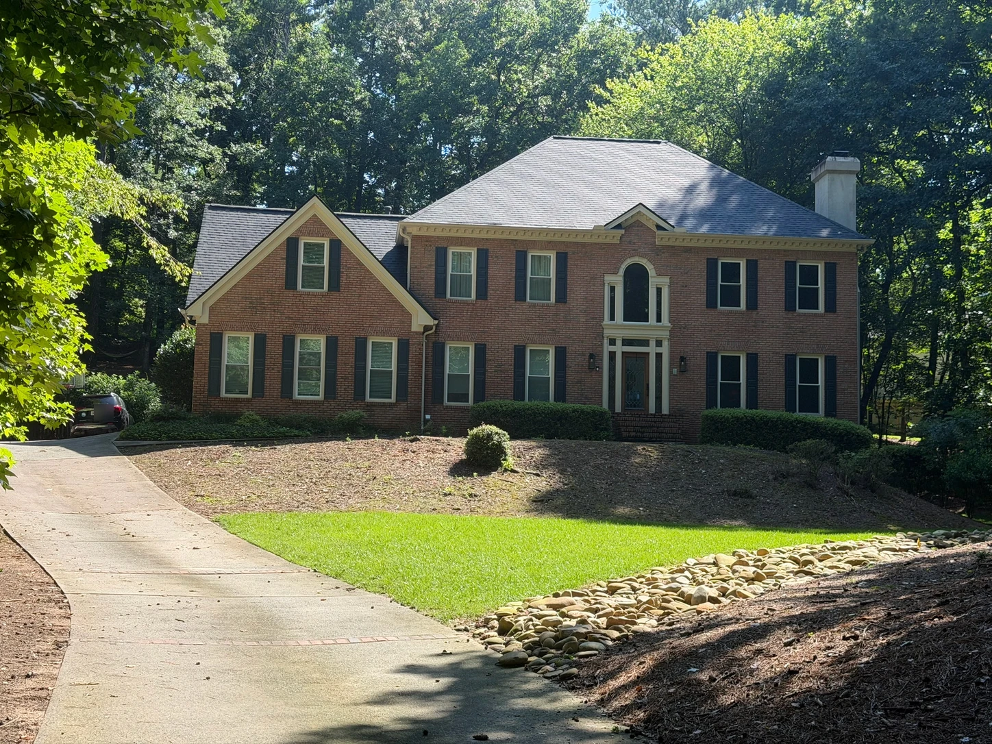 A large brick home, photographed as it is today